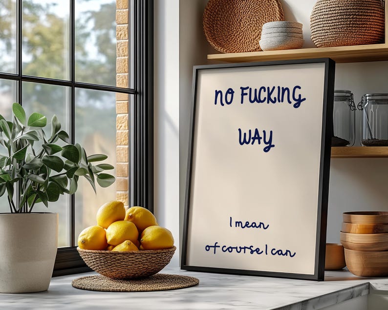 May include: A framed print with the text "no FUCKING WAY" and "I mean of course I can" in navy blue script. A bowl of lemons sits on a countertop near a window and a potted plant.