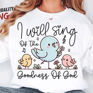 May include: White sweatshirt with a whimsical design featuring three cartoon birds and the text "I will sing of the Goodness of God." The central bird is light blue, holding a flower, with two smaller birds in yellow and pink.