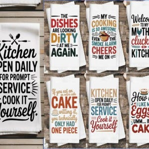May include: A selection of white kitchen towels with printed text in black, red, and blue. The towels display phrases such as "The Dishes Are Looking Dirty" and "Welcome to my Mother cluckin' Kitchen".