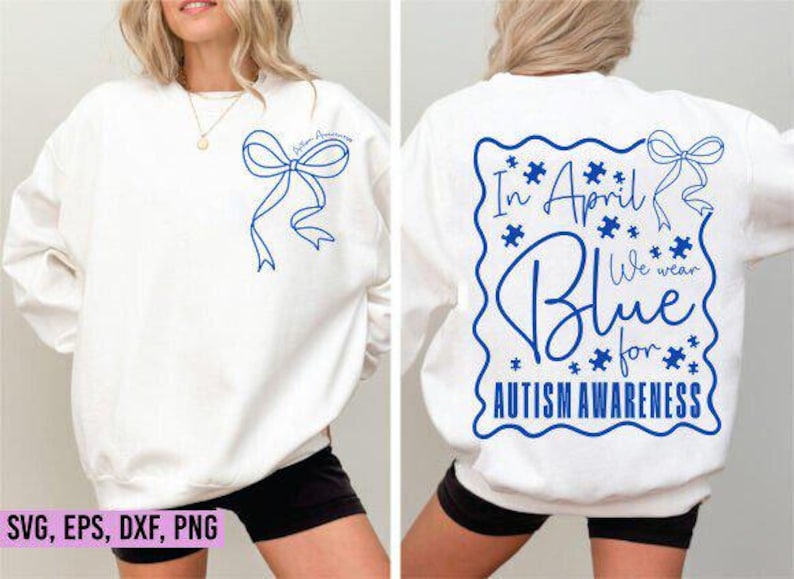May include: White sweatshirt with blue ribbon and text. The front features a blue ribbon design and the words "Autism Awareness". The back displays "In April We Wear Blue for Autism Awareness" in a blue design with puzzle pieces.