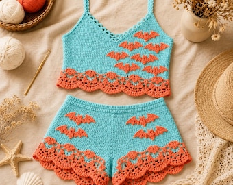 May include: A two-piece crochet set consisting of a light blue tank top and matching shorts. Both pieces feature orange bat-shaped appliqués and a decorative orange scalloped crochet border along the bottom edges of the top and the shorts.