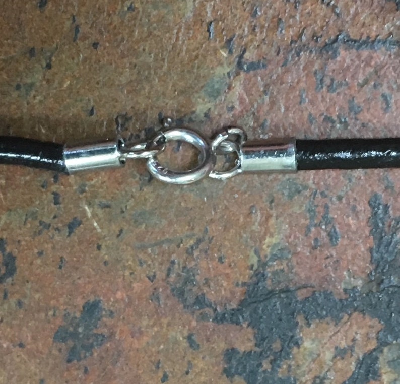 Black and white orthoceras fossil jasper circle pendant on a 20 leather cord packaged in a colorful gift bag 497A