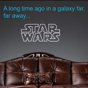 May include: A brown leather sofa with a decorative cushion and the text "A long time ago in a galaxy far, far away... STAR WARS" on the wall behind it.