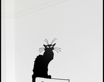 May include: Black silhouette of a cat with large eyes, sitting on a white wall. The cat's tail is curled around its body.