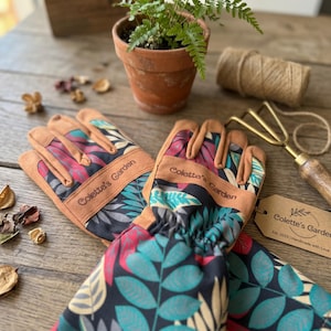 Personalized gardener gift gloves displayed on rustic garden table