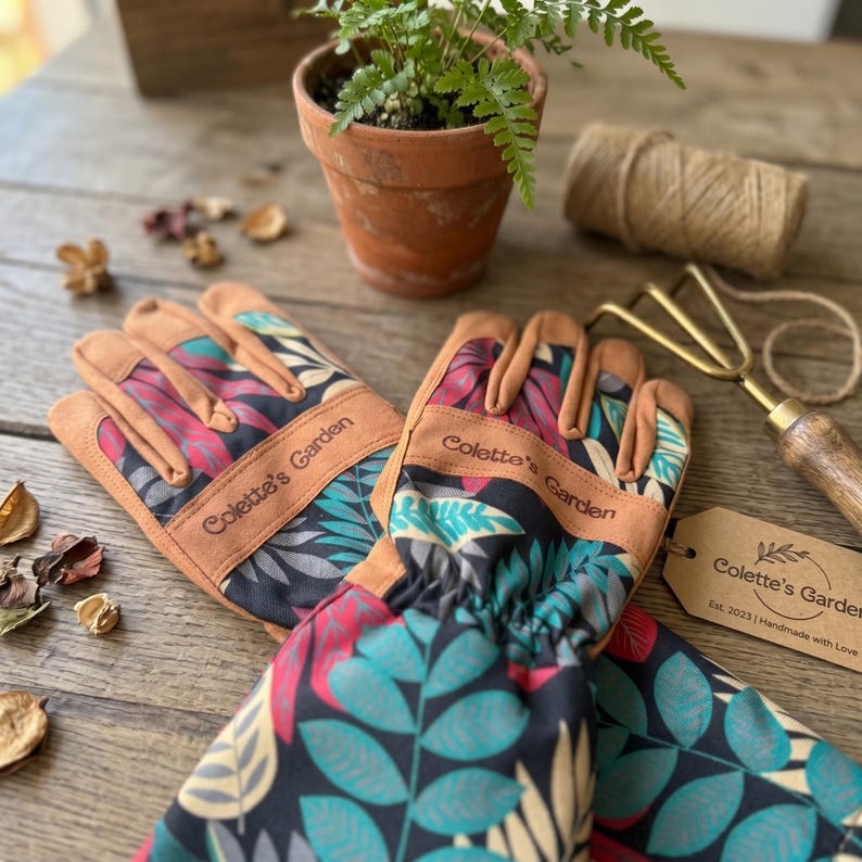 Personalized gardener gift gloves displayed on rustic garden table
