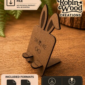 May include: A brown laser-cut wooden phone stand shaped like a rabbit with long ears, a bowtie, and whiskers. The digital file includes SVG and DXF formats for laser cutting, labeled with text including Digital File, Robin Wood Creations, and Included Formats.