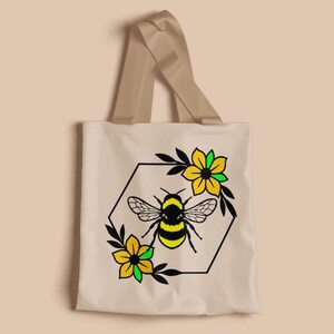 May include: Beige tote bag with a bee and floral design. The bee is black and yellow, surrounded by a black hexagon frame and yellow flowers with green accents. The bag has beige handles.