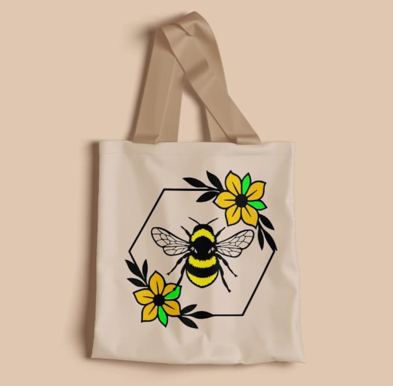 May include: Beige tote bag with a bee and floral design. The bee is black and yellow, surrounded by a black hexagon frame and yellow flowers with green accents. The bag has beige handles.