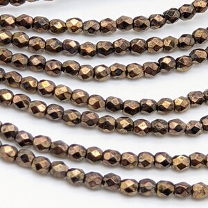 3mm Czech Glass beads. small faceted fire polished beads. color: Jet with Bronze Picasso (1404F)