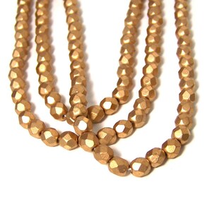 6mm Metallic gold glass beads, matte finish, faceted round 695G image 1