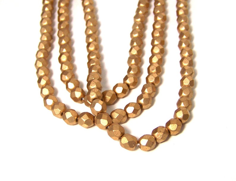 6mm Metallic gold glass beads, matte finish, faceted round 695G image 1