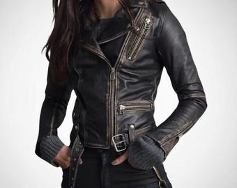 May include: A black leather jacket with a distressed, vintage look. The jacket features a zipper closure, multiple pockets, and a belt at the waist. The sleeves have zippered cuffs, and the jacket has a classic biker style.