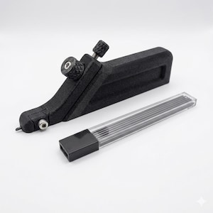 May include: A black 3D-printed mechanical marking tool with a textured finish, featuring two adjustable metal knobs and a small metal tip. Beside it lies a clear rectangular plastic case containing several thin black graphite lead refills.