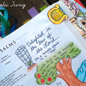 May include: A close-up of a page from a Bible with hand-drawn illustrations. The page is open to the book of Psalms and features a colorful drawing of a tomato plant with the text "Delighted in the law of the Lord... like a tomato plant in a "cage"... yields fruit in its season but not all the time. But leaves never wither."