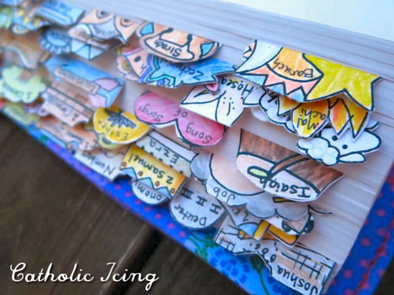 May include: A close-up of a book with colorful paper bookmarks. The bookmarks are labeled with names from the Bible, including Joshua, Isaiah, Malachi, Hosea, Zechariah, Baruch, and Sirach.