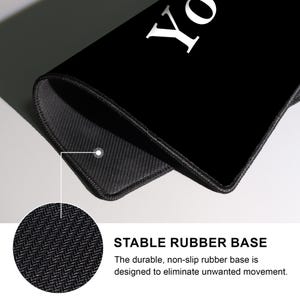 May include: Black rectangular mousepad with the word "YO" in white. The mousepad has a black, non-slip rubber base. Text on the image reads "STABLE RUBBER BASE" and "The durable, non-slip rubber base is designed to eliminate unwanted movement."