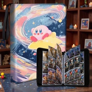 May include: A black zippered trading card binder featuring a colorful illustration of the pink character Kirby riding a yellow star against a swirling blue and purple cosmic background. The binder is open, revealing clear plastic pages holding cards.