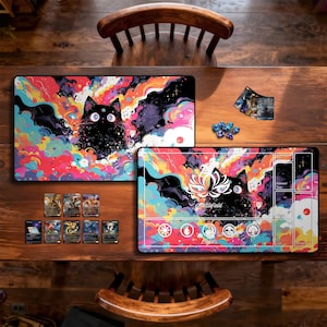 May include: Two rectangular playmats with colorful designs featuring a black cat with large eyes, surrounded by vibrant clouds and bat-like shapes. The mats are on a wooden table, with game cards and dice nearby.