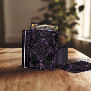 May include: A deck of trading cards featuring a dark purple and black design with an intricate geometric star pattern. The top card is clearly visible and displays the text Vaevictis Asmadi, with a mana cost symbol row and a legendary creature label.