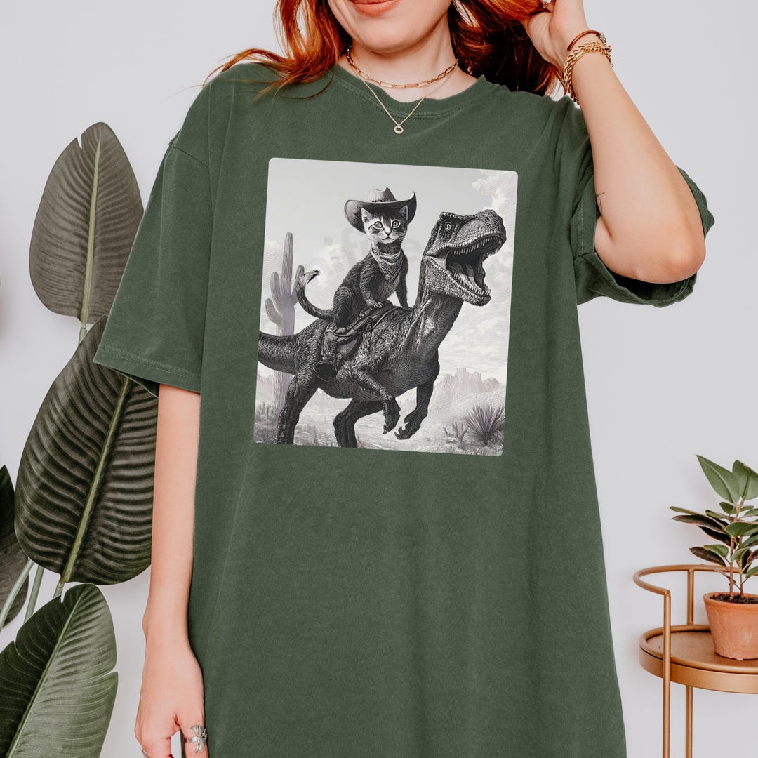 Cowboy Cat Riding T-rex T-shirt | Comfort Colors, Velociraptor, Fantasy ...