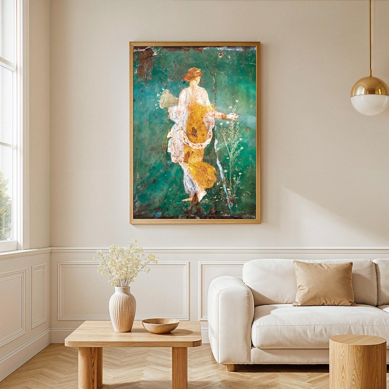 May include: A framed wall art print featuring a classical figure in a flowing yellow and white garment, set against a deep emerald green background. The figure holds a cornucopia and stands amidst delicate white flowers in a vertical composition.