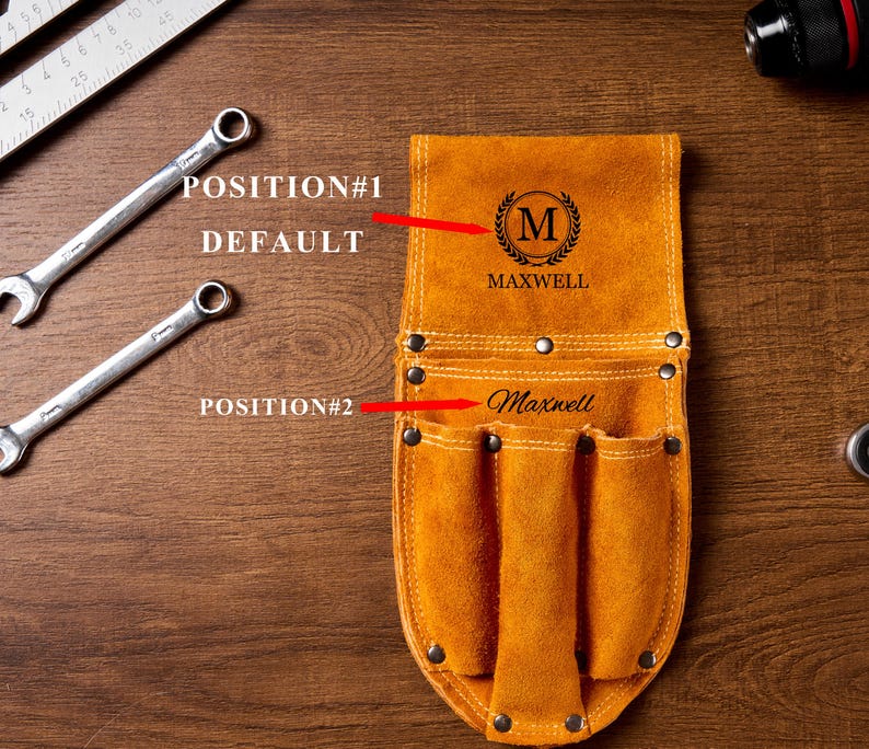 May include: A tan leather tool belt with multiple pockets and the name "Maxwell" engraved on it. The belt has a decorative "M" emblem and is shown with two spanners and a ruler on a wooden surface.