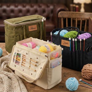 May include: Three fabric craft storage bags in olive green, black, and beige. The bags are filled with yarn, knitting needles, and crochet hooks. The beige bag has a flap with wooden crochet hooks and a clear plastic container.
