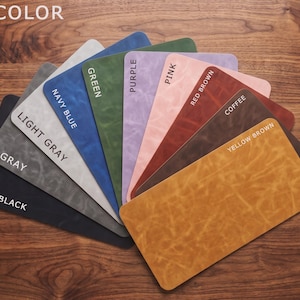 May include: A fan-shaped display of rectangular swatches featuring various colors including black, gray, light gray, navy blue, green, purple, pink, red brown, coffee, and yellow brown. Each swatch is labeled with its corresponding color name.