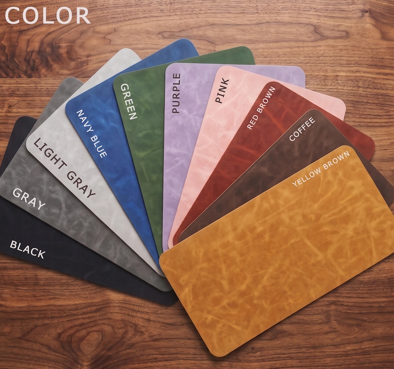 May include: A fan-shaped display of rectangular swatches featuring various colors including black, gray, light gray, navy blue, green, purple, pink, red brown, coffee, and yellow brown. Each swatch is labeled with its corresponding color name.