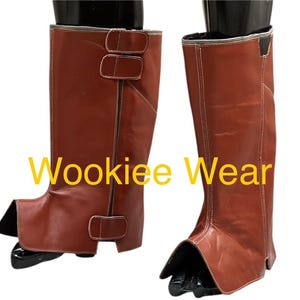May include: Brown leather boots with white stitching and buckle details. The boots have a unique design with a separate foot covering. The text "Wookiee Wear" is visible on the image.