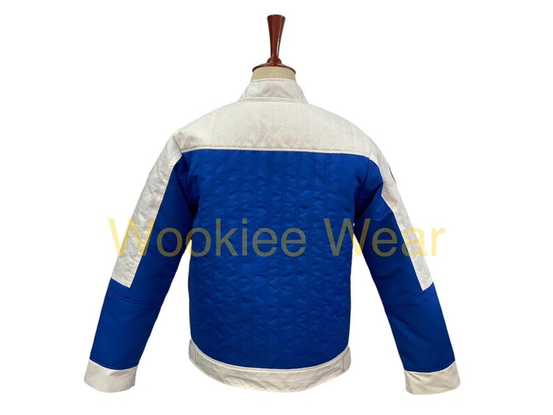 May include: A blue and white jacket with a quilted pattern. The jacket has a white collar, shoulders, and cuffs, with a blue body. The text "Wookiee Wear" is visible on the jacket.