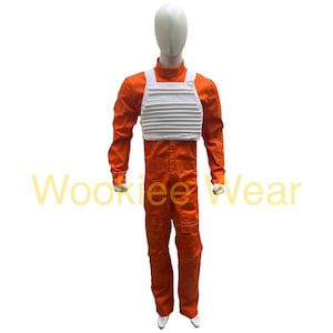 May include: An orange jumpsuit with a white chest plate, displayed on a mannequin. The costume has long sleeves and trousers, with a white ribbed vest. The text "Wookiee Wear" is visible in the image.