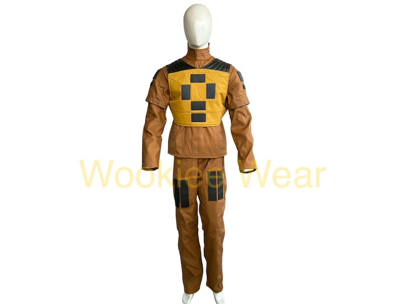 May include: A brown and yellow costume with black accents, displayed on a mannequin. The costume includes a jacket and pants. The jacket has a yellow chest piece with black squares. The pants have black patches on the knees. The text "Wookie Wear" is visible.