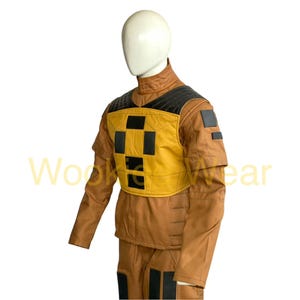 May include: A brown and yellow costume with black accents, displayed on a mannequin. The costume features a yellow chest piece with black squares and a black collar. The sleeves are long and the pants are visible at the bottom.