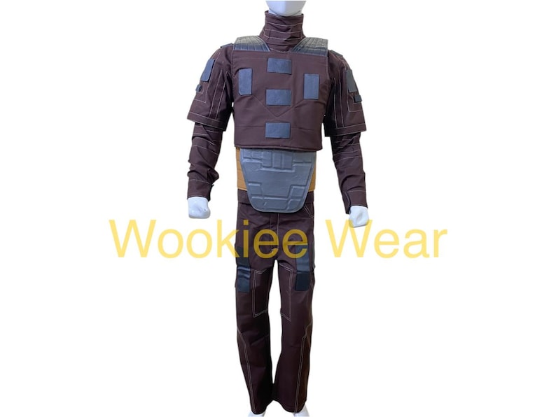 May include: A brown costume with a high collar, shoulder pads, and a chest plate. The costume includes matching pants and is displayed on a white background. The text "Wookiee Wear" is visible.
