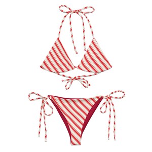 May include: A two-piece bikini set with a red and white striped pattern. The top is a halter style with triangle cups, and the bottom is a classic bikini cut. The set is tied with matching red and white striped ties.