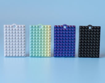 Plato texturizado sensorial con pinchos con correa para la muñeca o llavero