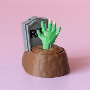 Zombie Hand in Grave Spooky Halloween Fidget Clicker Desk Toy with Wrist Strap or Keychain