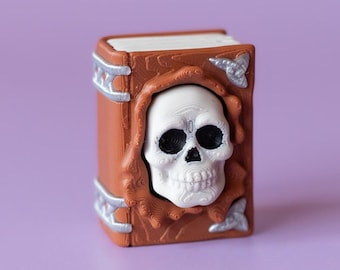 スカルフェイスの魔法書、不気味なハロウィーンフィジェットクリッカー、リストストラップまたはキーチェーン付き