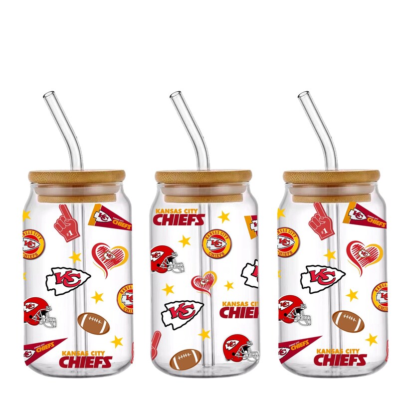 May include: Three clear glass tumblers with bamboo lids and glass straws. Each tumbler is decorated with Kansas City Chiefs logos, helmets, footballs, and the words "Kansas City Chiefs".