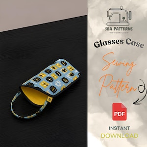 May include: A glasses case sewing pattern PDF featuring a light blue fabric with a repeating pattern of black and yellow cat faces. The case has a yellow interior lining, a black trim, and a matching fabric loop handle. Text includes Sea Patterns.