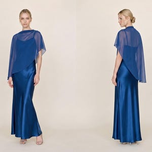 This soft blush silk dress with a delicate detachable sheer cape combines graceful elegance with modern design, perfect for bridal events, wedding receptions, or as a thoughtful bridesmaid gift. Featuring a cowl neckline and asymmetrical cape hem, it offers a refined, feminine look that flows effortlessly. A perfect gift for bridesmaids or wedding guests, it brings a luxurious and sophisticated touch to any celebration of love.