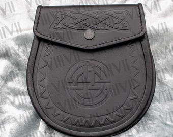 May include: A dark brown leather sporran featuring an embossed circular Celtic knot design in the center and a decorative braided pattern on the flap. The pouch has a single snap button closure and a zigzag border detail along the bottom edge.