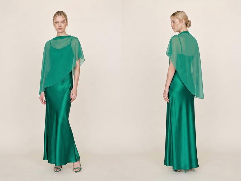 This luxurious emerald green silk maxi dress with a detachable sheer cape exudes elegance and timeless beauty, ideal for wedding guests, bridesmaids, or even as a thoughtful bridal shower gift. The cowl neckline and asymmetrical cape hem create an elegant movement that is both striking and graceful. It’s perfect for formal events, creating a chic and sophisticated bridal look, and serves as a refined gift for those celebrating love and commitment.