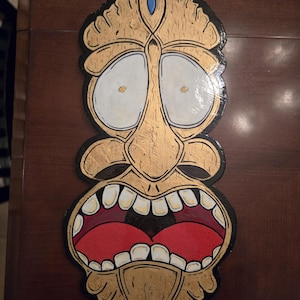 painted tiki head on wood