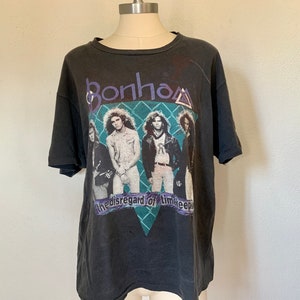 May include: Black vintage t-shirt featuring a band photo of Bonham with the text "the disregard of time keeps".