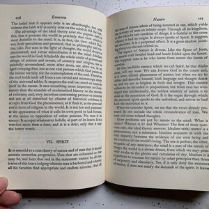 May include: Open book with text on pages 106 and 107, titled "Emerson" and "Nature." The pages are aged with visible wear. The book is open to a double-page spread, with text in black font.