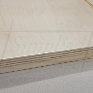 May include: A light-colored wooden board with a visible layered plywood edge, featuring two vertical threaded metal rods secured with nuts and washers at the corners. The surface displays a faint logo and the text 210-1 printed on the side.