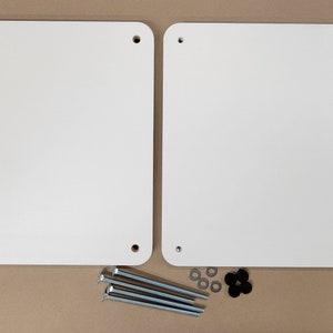 May include: Two white rectangular panels with four holes each, and four silver screws and four silver washers, and one black plastic washer.